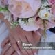 hands with a ring of the bride and groom with a wedding bouquet hands with a ring of the bride and groom with a wedding bouquet